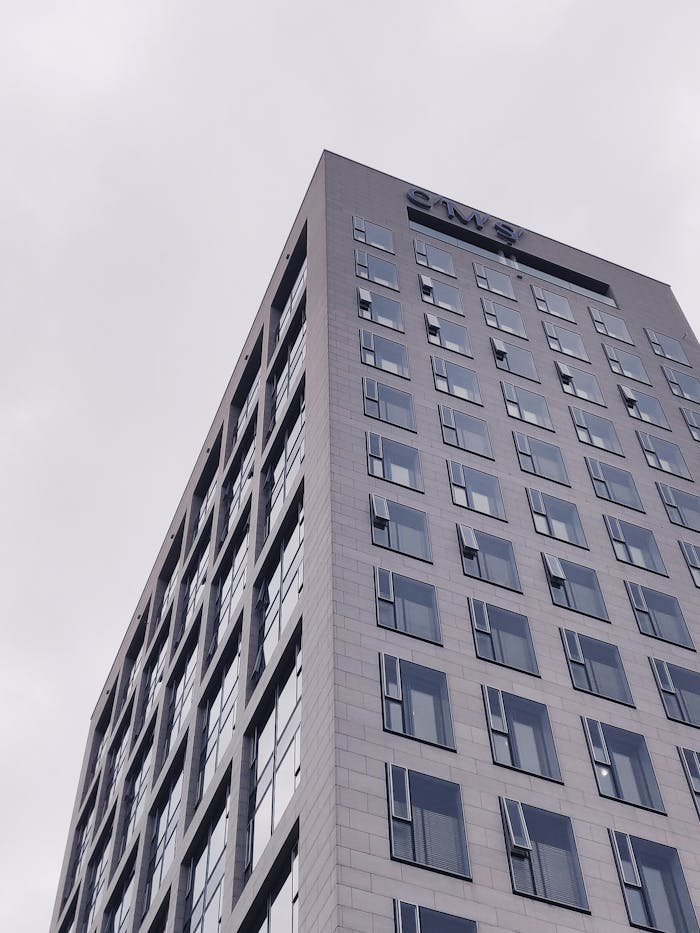 Low angle view of a modern skyscraper with windows in Frankfurt, showcasing urban architecture.